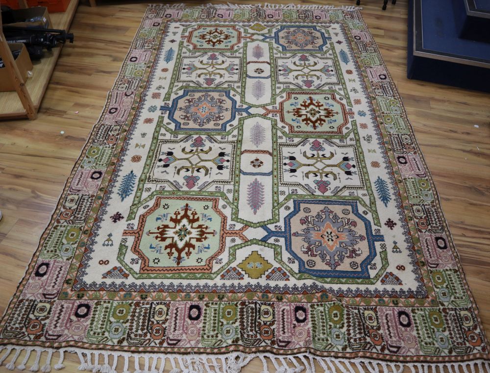 A Caucasian design ivory ground rug, 320 x 195cm